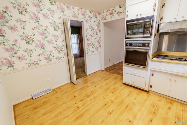 kitchen featuring white gas cooktop, white cabinets, oven, built in microwave, and light hardwood / wood-style floors