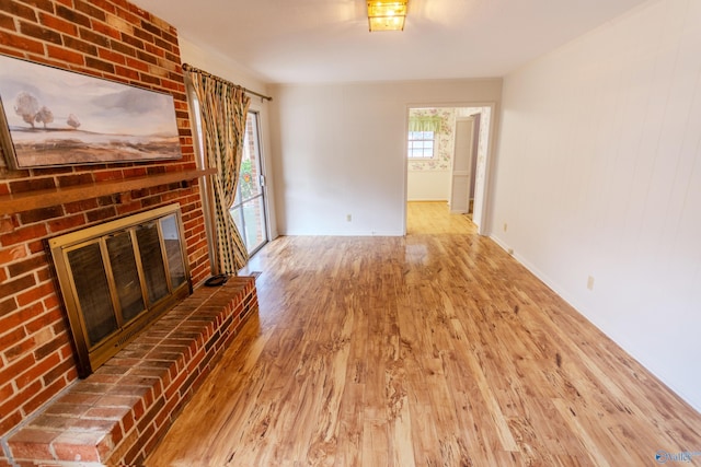 unfurnished living room with a fireplace and hardwood / wood-style floors