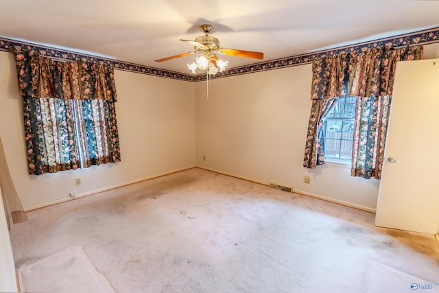 empty room featuring carpet flooring and ceiling fan