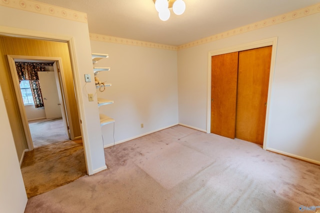 unfurnished bedroom with light carpet and a closet