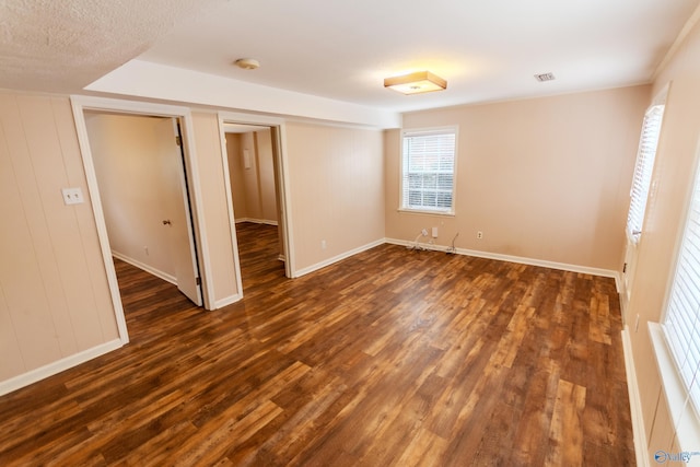 spare room featuring dark wood-type flooring