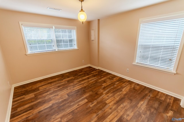 spare room featuring dark hardwood / wood-style floors