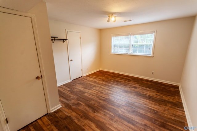 spare room featuring dark hardwood / wood-style floors