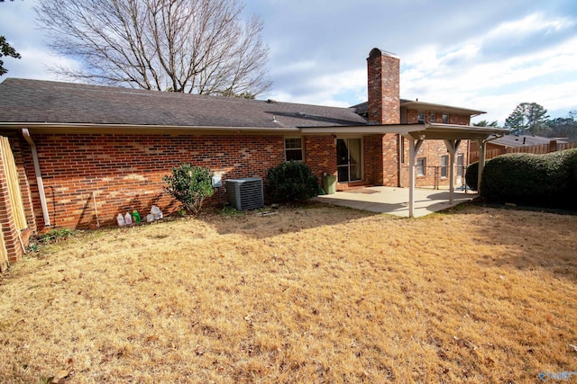 back of house featuring a lawn, a patio area, and central AC unit