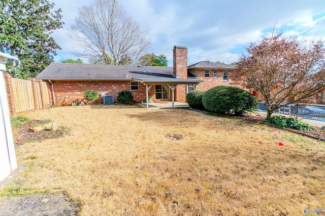 rear view of house with central AC