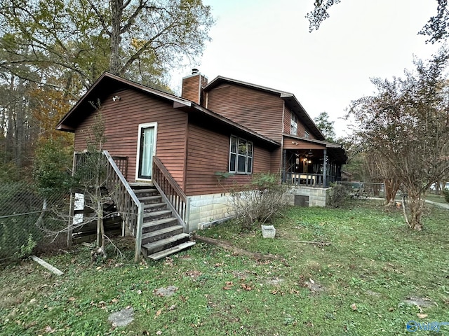 rear view of property with a lawn