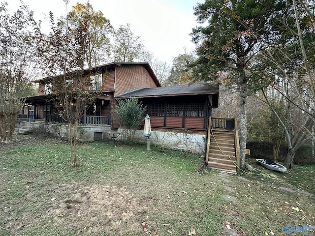 back of house with a lawn