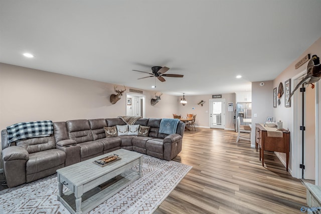 living area with light wood-style flooring, recessed lighting, baseboards, and ceiling fan