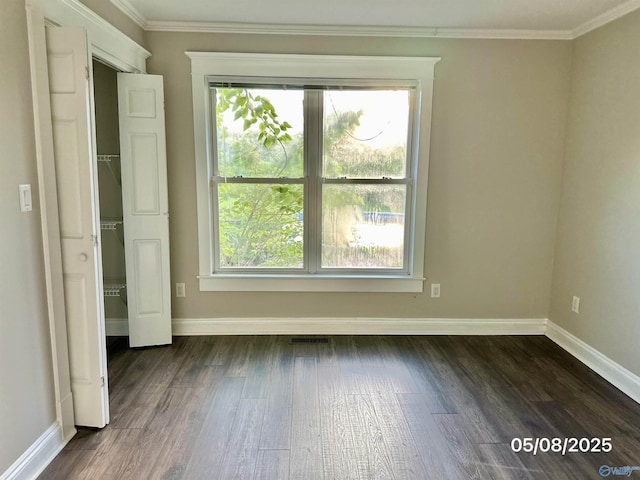 2494 Hines St S, Athens, AL 35611 - unfurnished bedroom with baseboards, multiple windows, dark wood-style floors, and crown molding