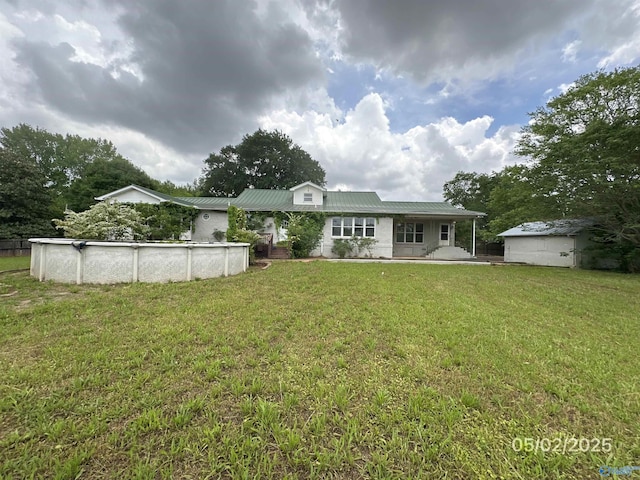 2494 Hines St S, Athens, AL 35611 - back of property with an outdoor pool, a yard, and metal roof