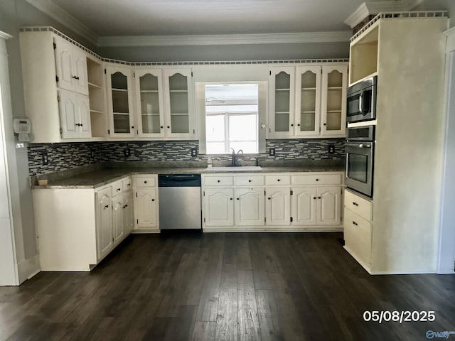 2494 Hines St S, Athens, AL 35611 - kitchen with stainless steel appliances, a sink, glass insert cabinets, tasteful backsplash, and dark wood finished floors