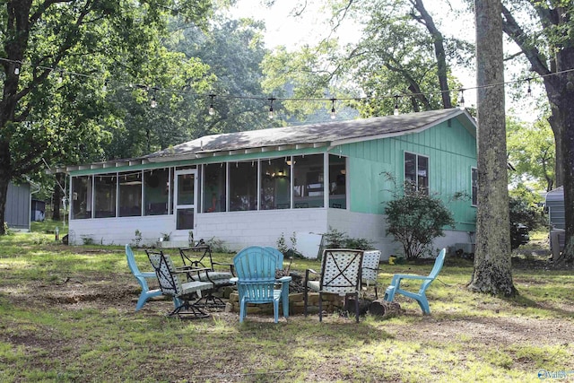 1700 County Road 102, Cedar Bluff, AL 35959 - rear view of property with a sunroom, a shingled roof, and a yard