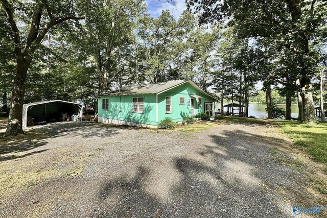 1700 County Road 102, Cedar Bluff, AL 35959 - view of front of house featuring gravel driveway, a carport, and a water view