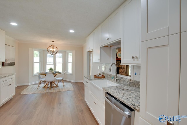 kitchen featuring light wood-style flooring, a sink, white cabinetry, stainless steel dishwasher, and tasteful backsplash