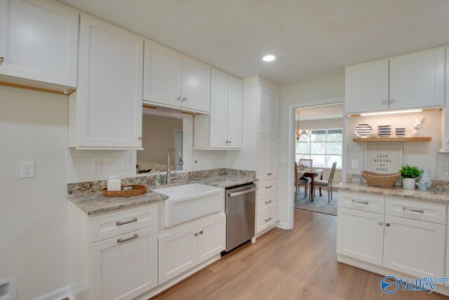 15011 Glory Dr SE, Huntsville, AL 35803 - kitchen with dishwasher, white cabinetry, a sink, and light wood finished floors