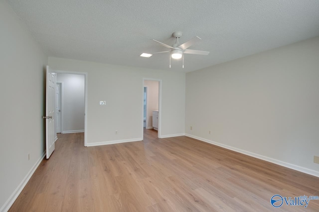 unfurnished bedroom with a ceiling fan, light wood-type flooring, a textured ceiling, and baseboards