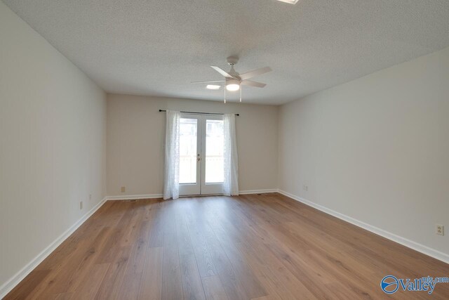 15011 Glory Dr SE, Huntsville, AL 35803 - spare room featuring wood finished floors, french doors, baseboards, a textured ceiling, and ceiling fan