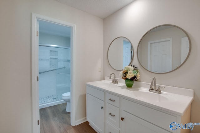 bathroom featuring a sink, toilet, and a shower stall