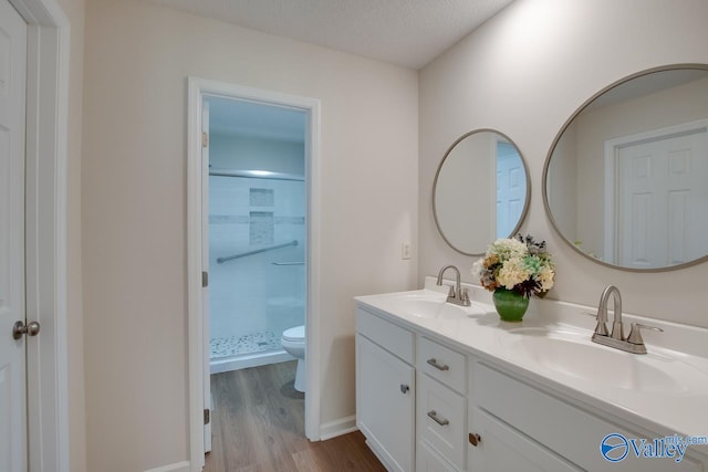 full bath with a sink, toilet, and a shower stall