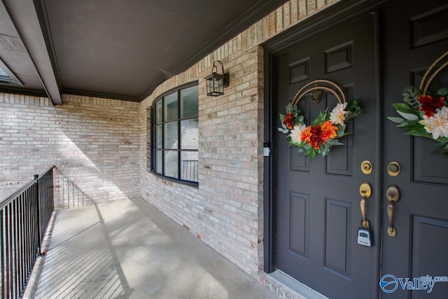 view of exterior entry featuring brick siding