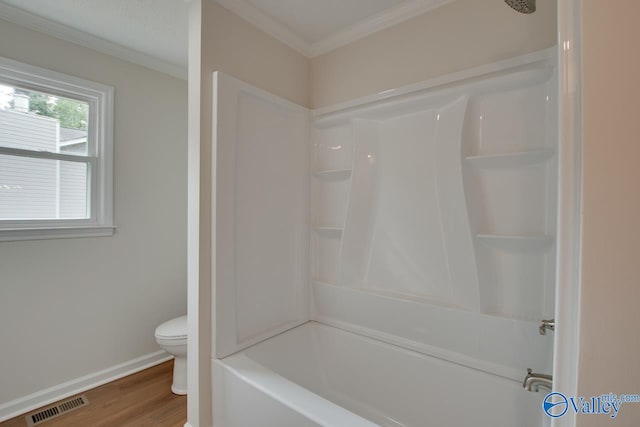 bathroom featuring toilet, wood finished floors, visible vents, baseboards, and crown molding