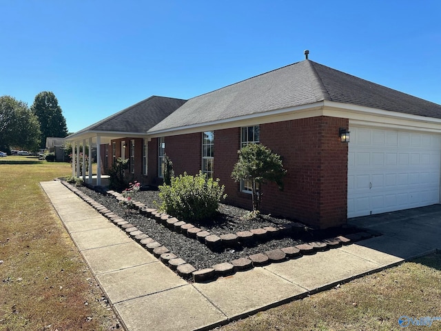 view of front of property with a front lawn and a garage