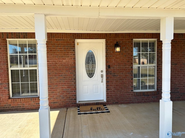 view of exterior entry featuring a porch