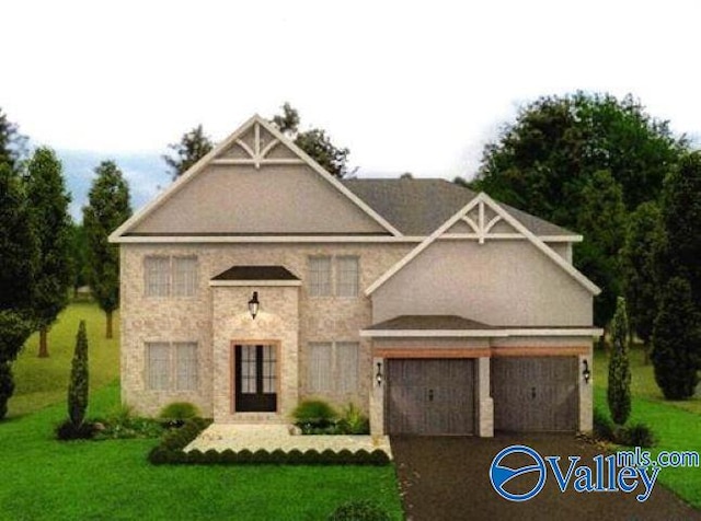 view of front of house with a garage and a front lawn