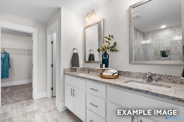 120 Burdine St, New Market, AL 35761 - full bathroom with a walk in closet, a sink, baseboards, and visible vents