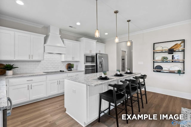 120 Burdine St, New Market, AL 35761 - kitchen featuring stainless steel appliances, custom exhaust hood, a kitchen island, ornamental molding, and white cabinets