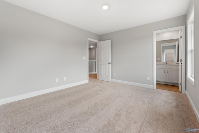 120 Burdine St, New Market, AL 35761 - unfurnished bedroom featuring ensuite bath, light colored carpet, and baseboards