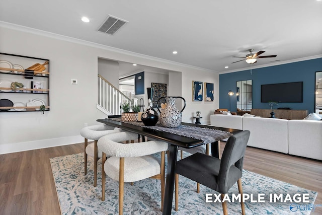 120 Burdine St, New Market, AL 35761 - dining area featuring visible vents, ceiling fan, stairs, and crown molding