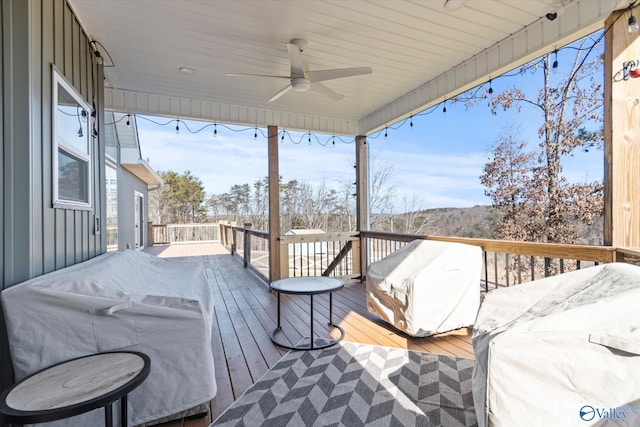 wooden deck featuring ceiling fan and area for grilling