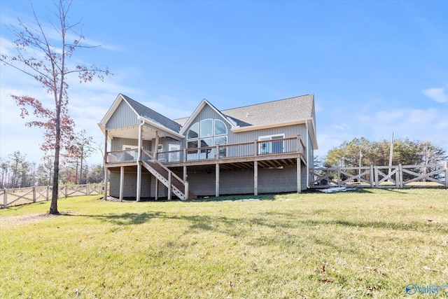 back of property featuring a lawn and a deck