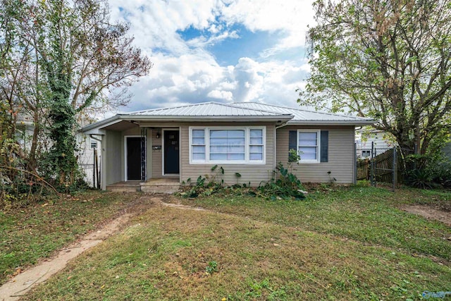 view of front of property with metal roof, a porch, a front yard, and fence