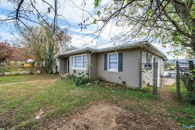 view of front of house featuring cooling unit and fence
