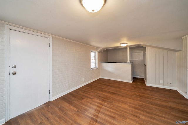 interior space with brick wall and wood finished floors