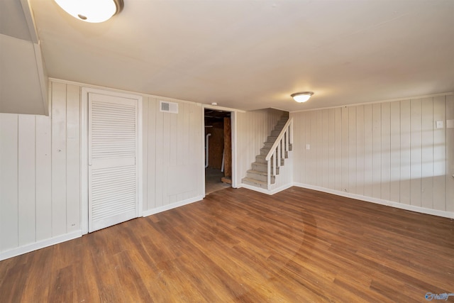 interior space featuring stairway, wood finished floors, visible vents, and baseboards