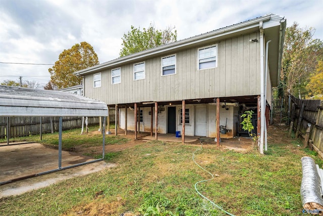 rear view of house featuring a patio, a yard, a fenced backyard, and a carport