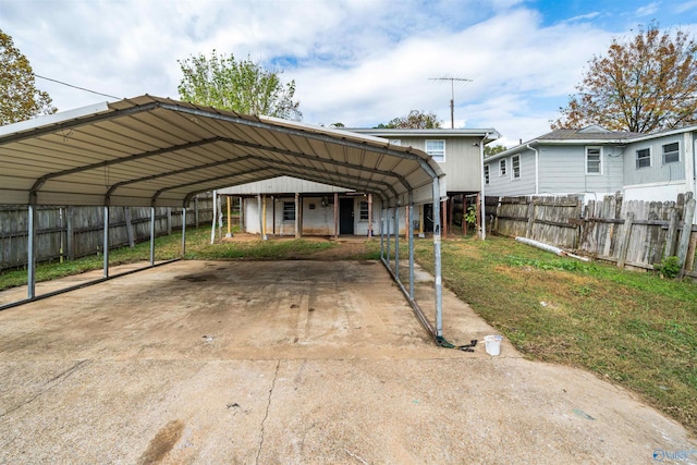 view of parking featuring a carport and fence
