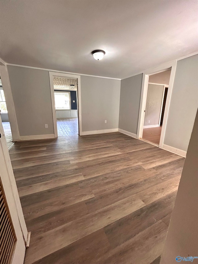 empty room with a healthy amount of sunlight and dark hardwood / wood-style floors