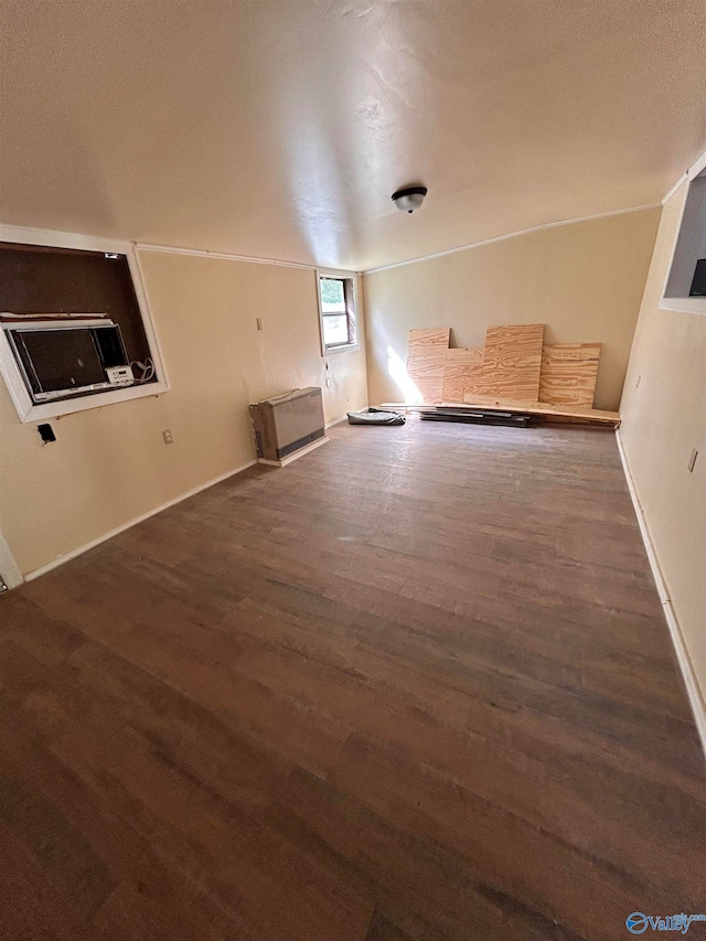 interior space featuring a textured ceiling and dark hardwood / wood-style floors