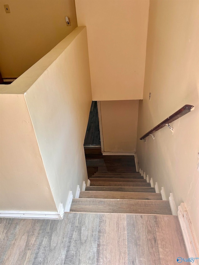 stairs featuring wood-type flooring