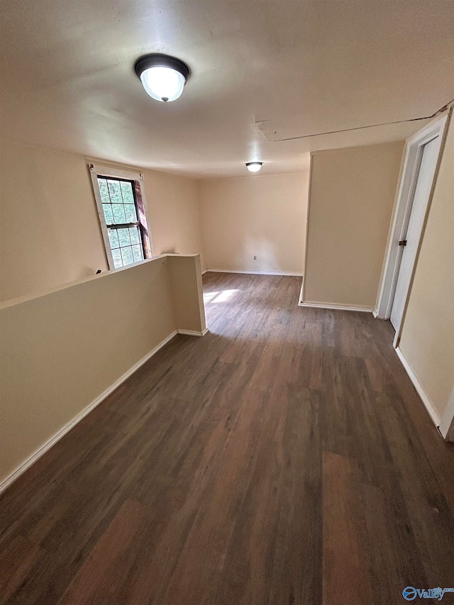 unfurnished room featuring dark wood-type flooring