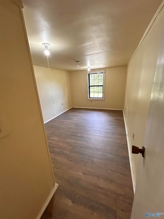 spare room featuring dark wood-type flooring