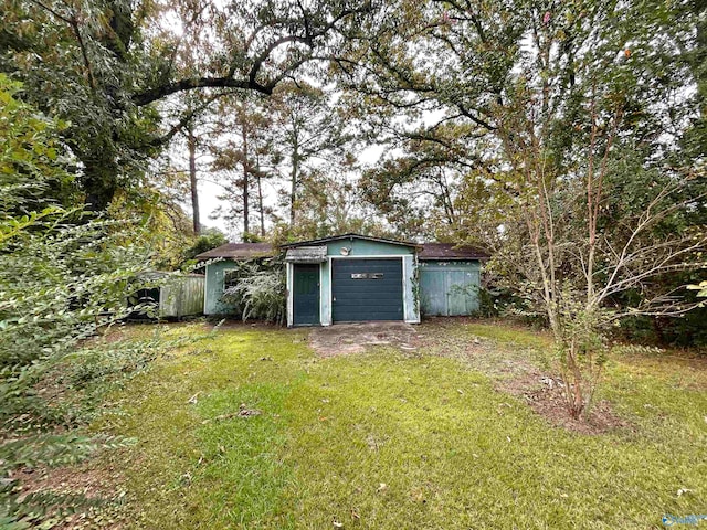 view of outbuilding with a garage and a yard