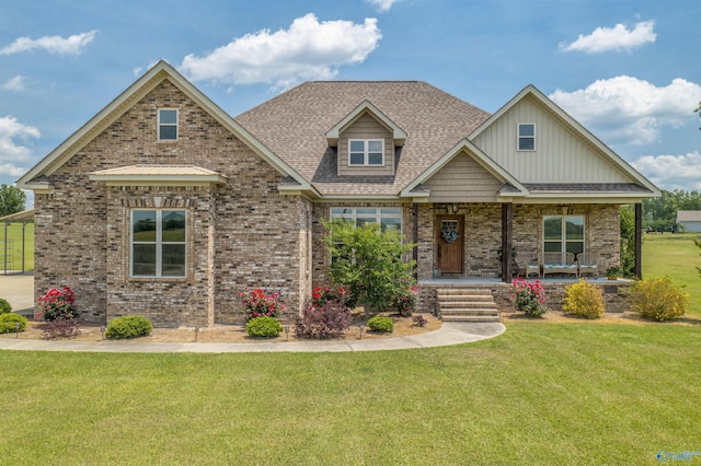 craftsman inspired home featuring covered porch and a front lawn