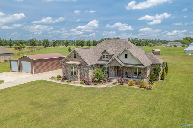 craftsman-style home with a garage, an outdoor structure, covered porch, and a front yard