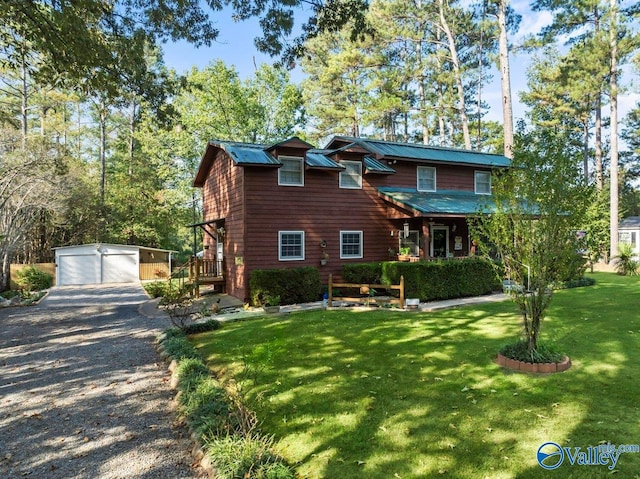 view of front of house featuring a front yard, an outdoor structure, and a garage