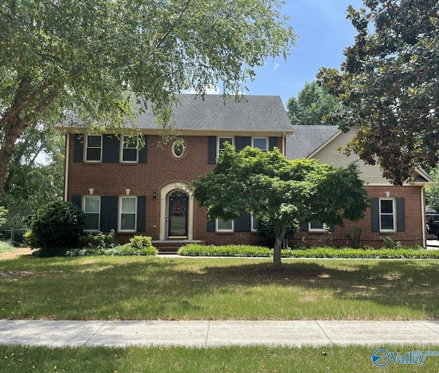 colonial house featuring a front lawn